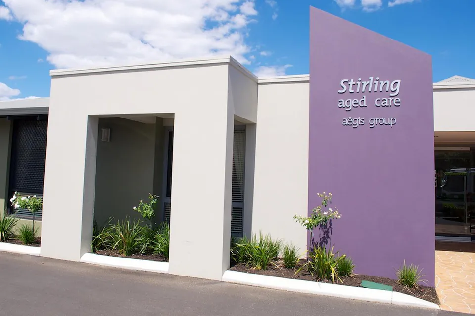 Residence entrance with a purple aged-care sign.