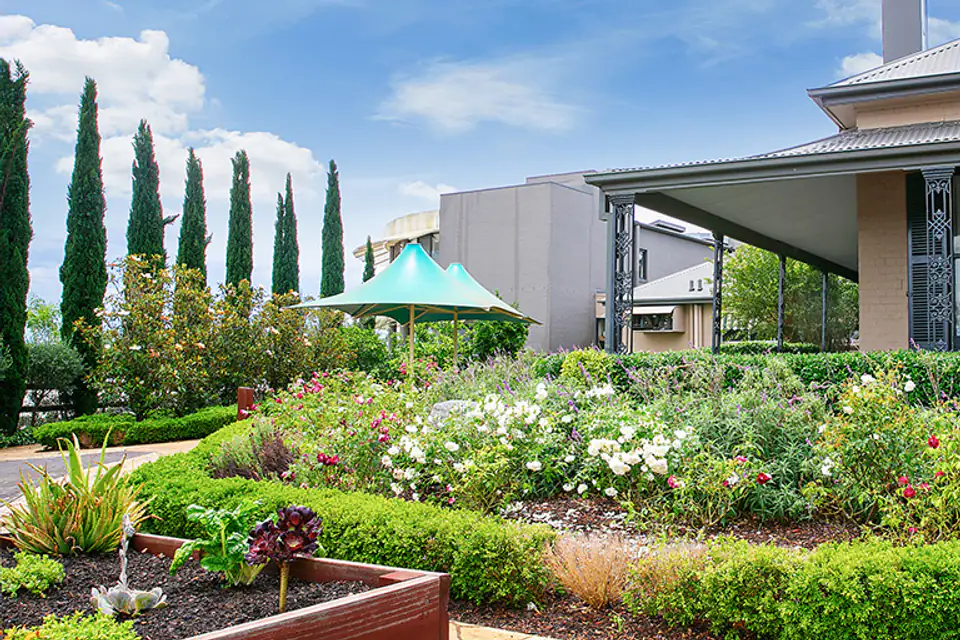 Raised garden beds beside a low building