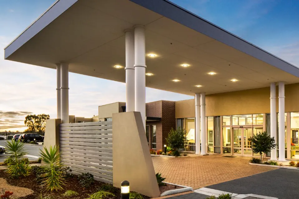 Entrance portico lit at dusk