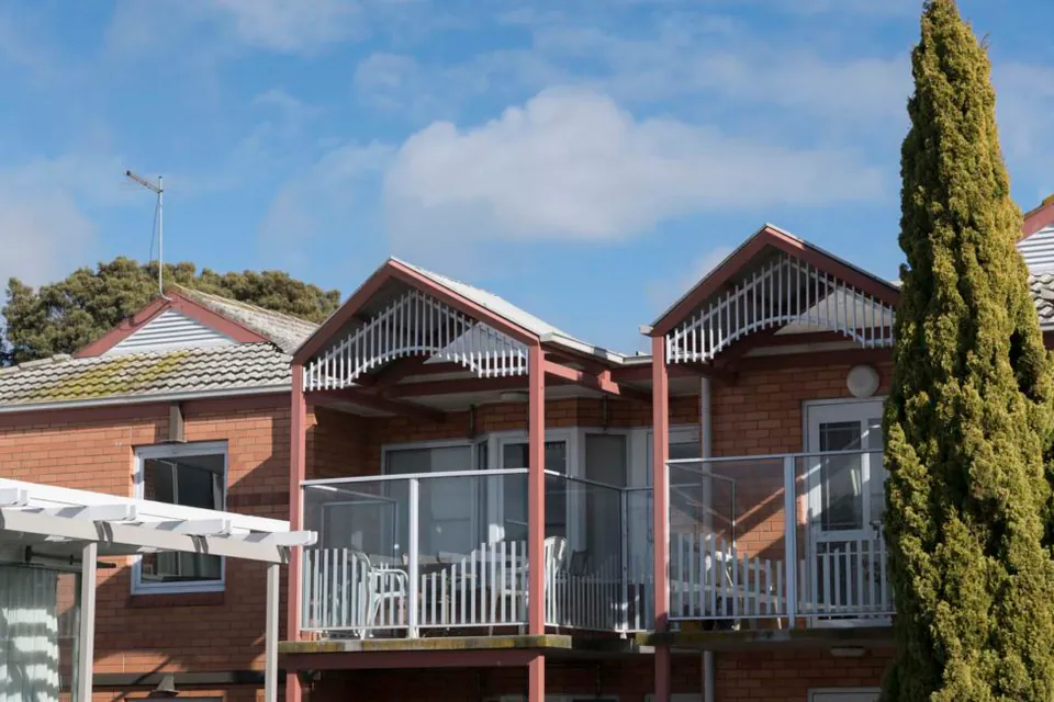 Brick building with balconies and garden beds