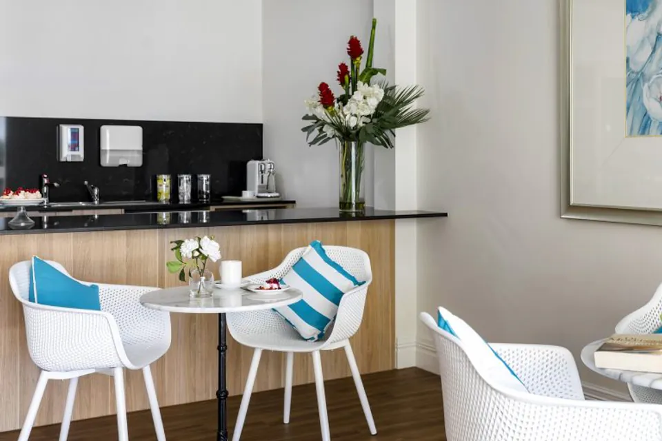 Cafe seating beside a small kitchenette.