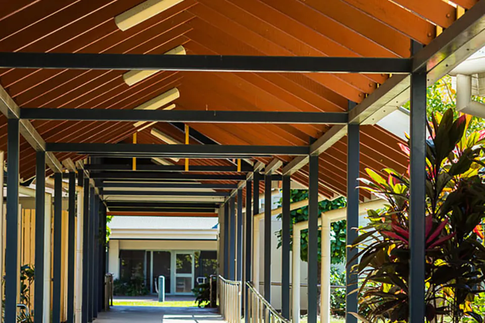 Covered walkway through landscaped gardens