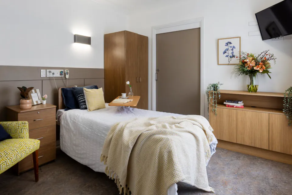 Bedroom with a single bed and armchair
