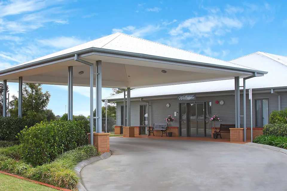 Covered entrance and driveway at the single-storey residence