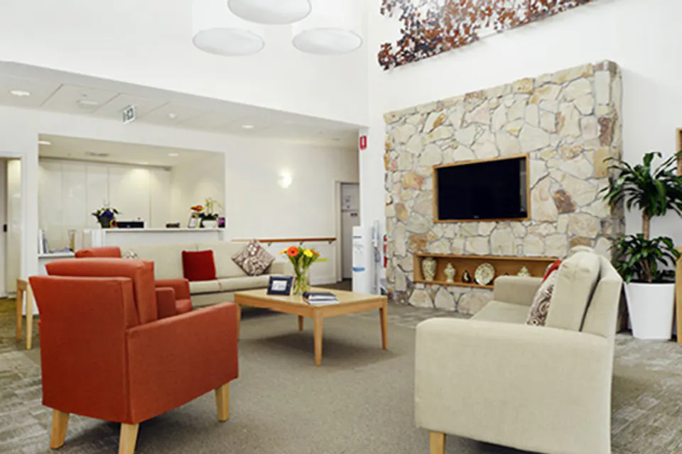 Lounge with a stone fireplace and sofas
