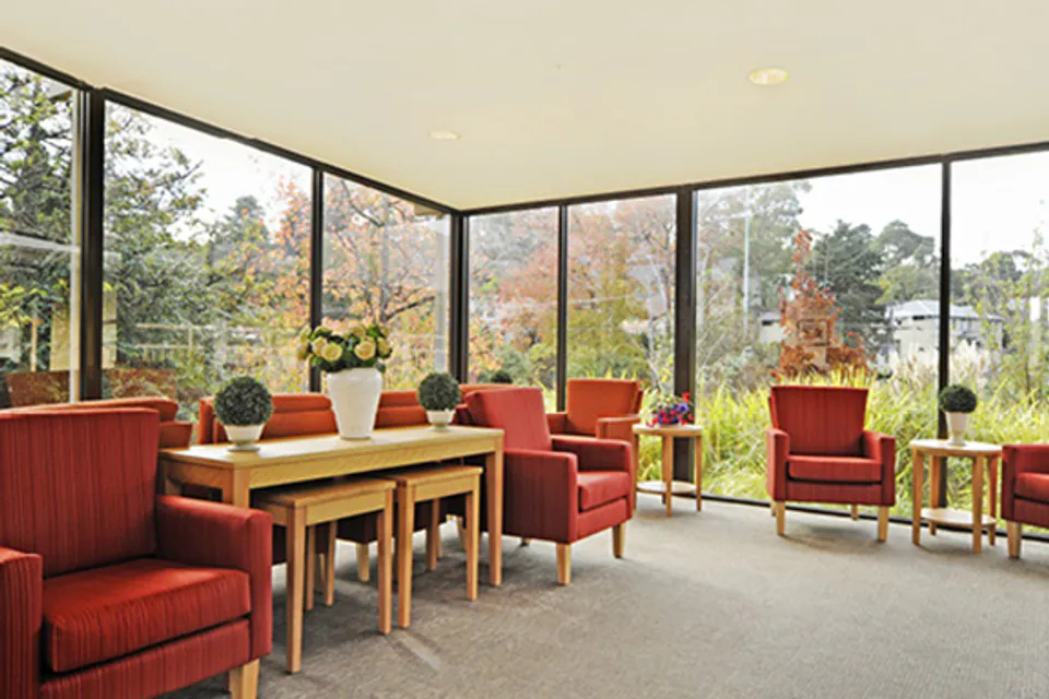 Tables and chairs in a sunlit sitting room