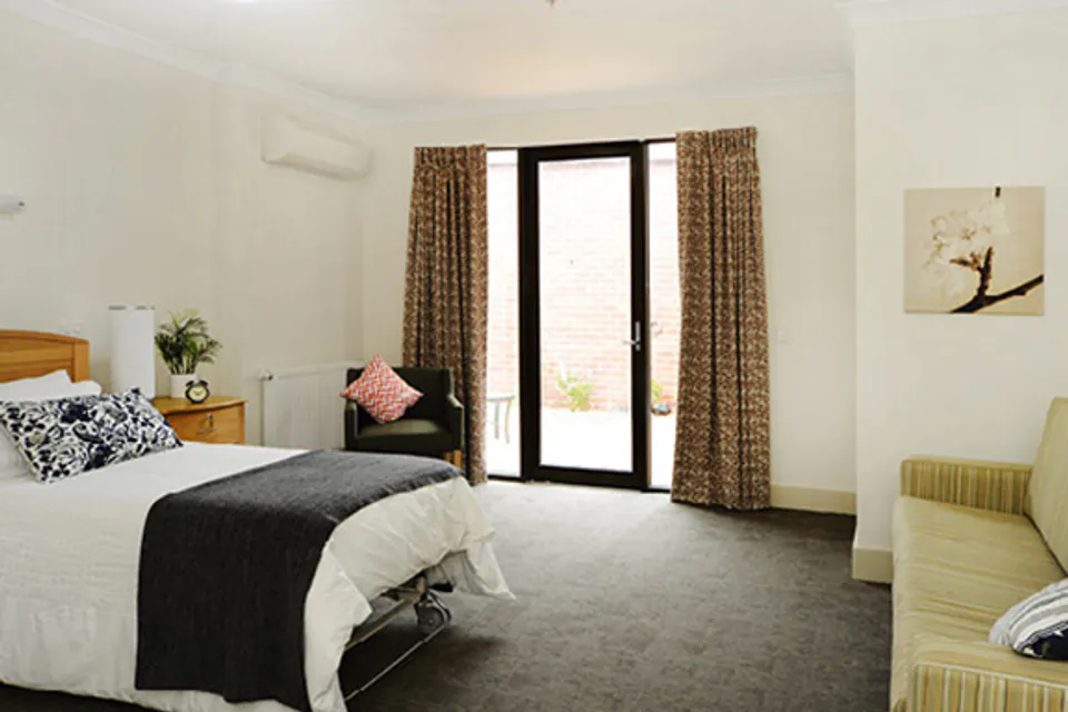 Bedroom opening to a balcony