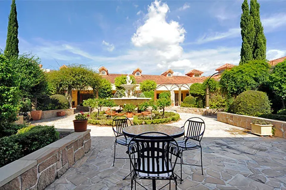 Courtyard table surrounded by garden beds