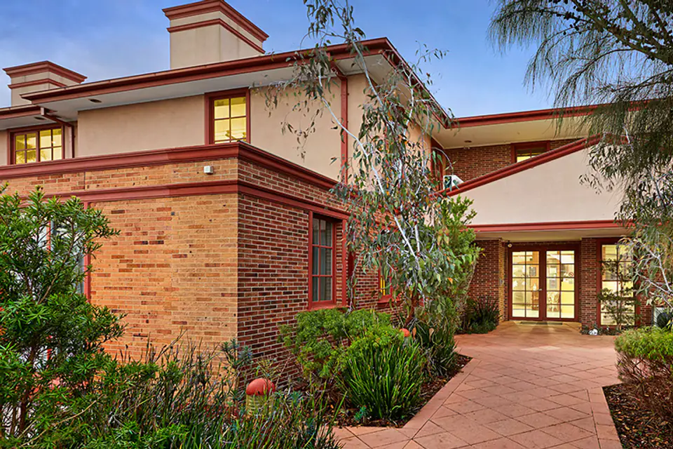Brick residence with a landscaped entrance