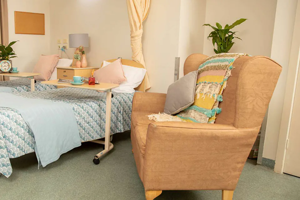 Bedroom with a single bed and armchair
