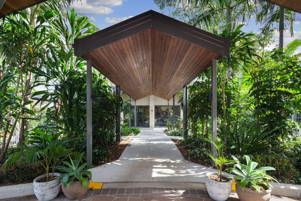Covered walkway through planted gardens