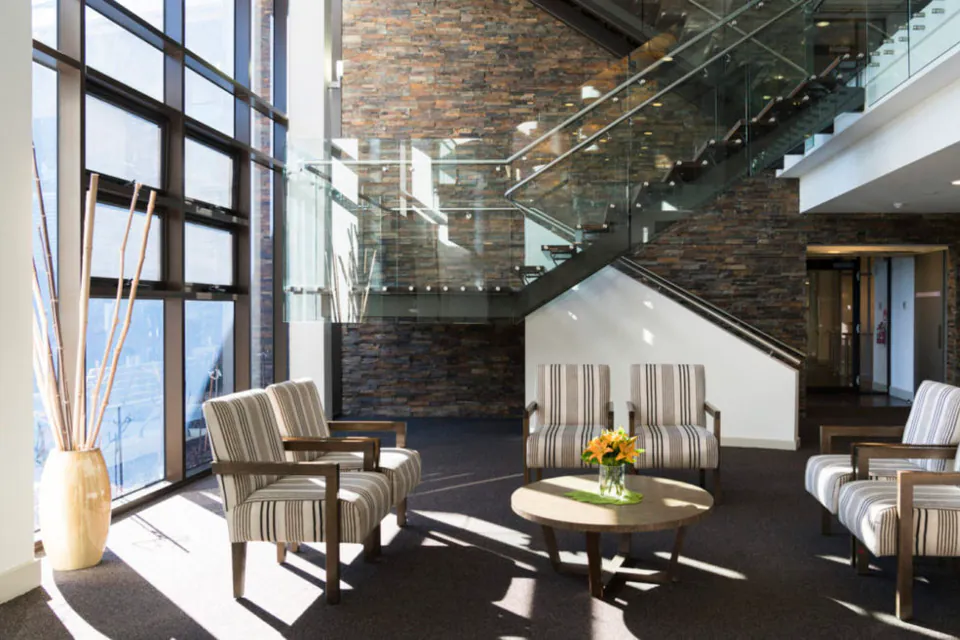 Atrium lounge beneath a glass staircase
