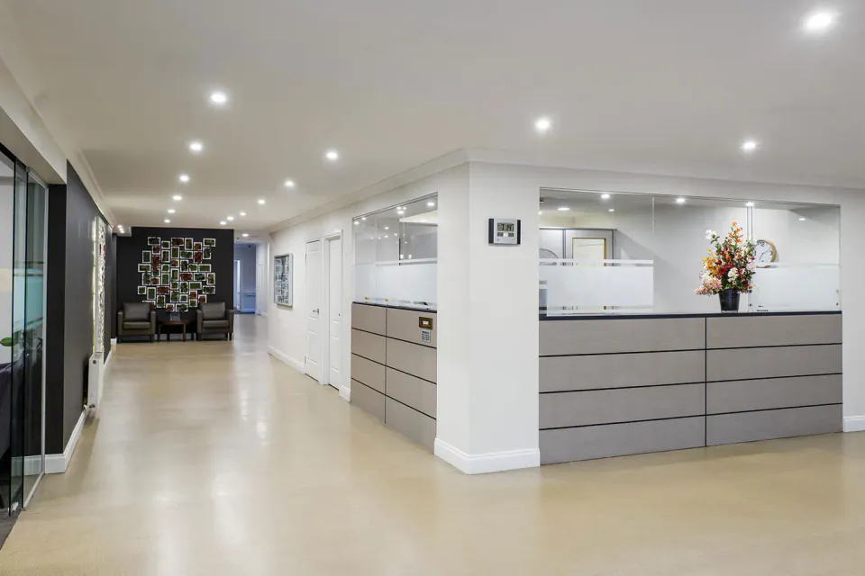 Reception desk along a bright entrance corridor