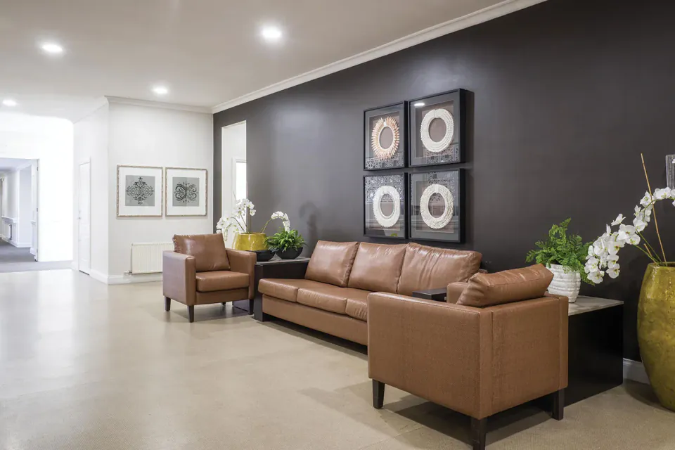 Lounge with brown sofas and wall art