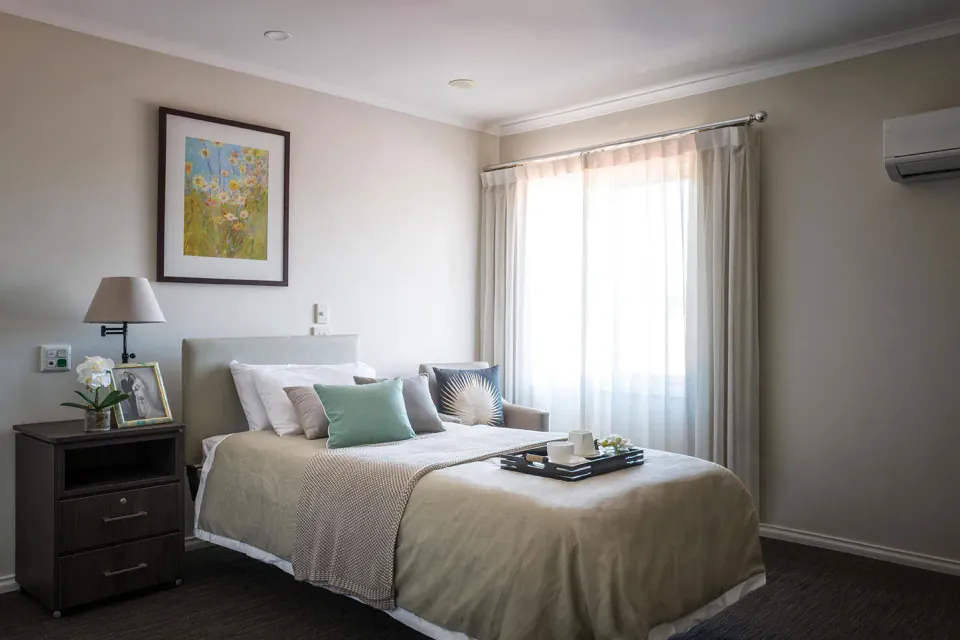 Bedroom with a bed and curtained window