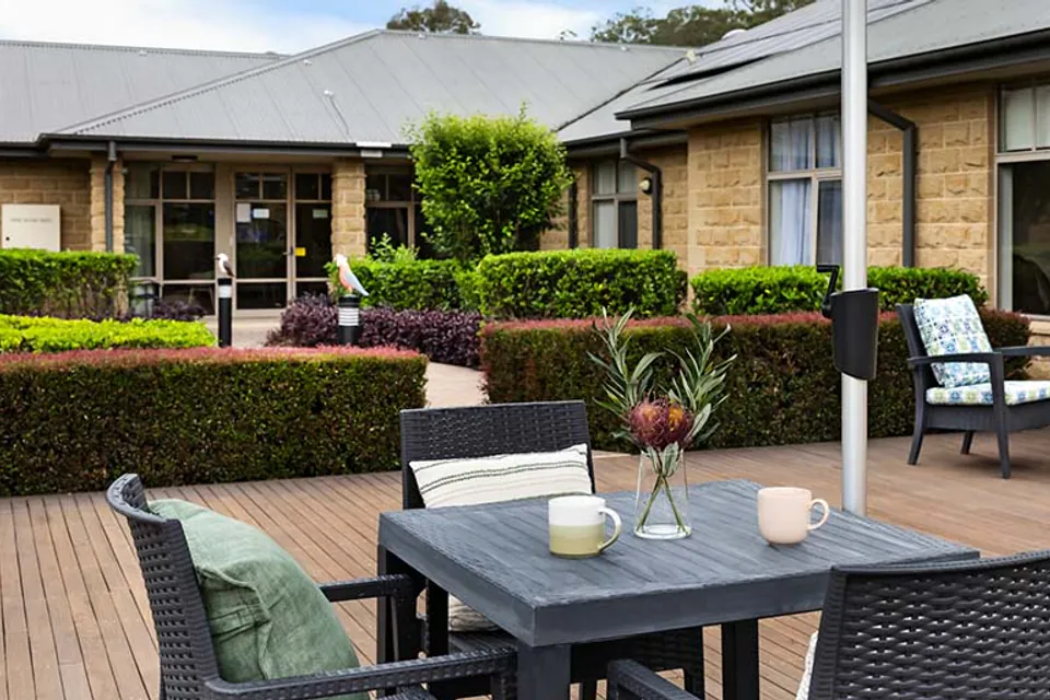 Outdoor patio with tables beside flower beds