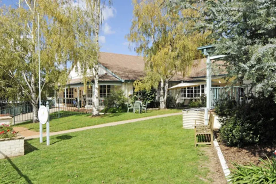 Residence across a lawn and trees