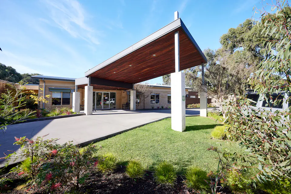 Covered entrance and landscaped driveway outside the residence