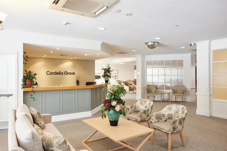 Reception and sitting area with armchairs and flowers