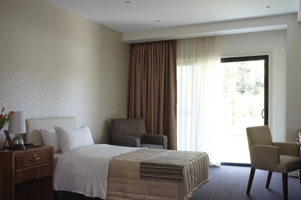 Bedroom with a double bed and doors to the courtyard