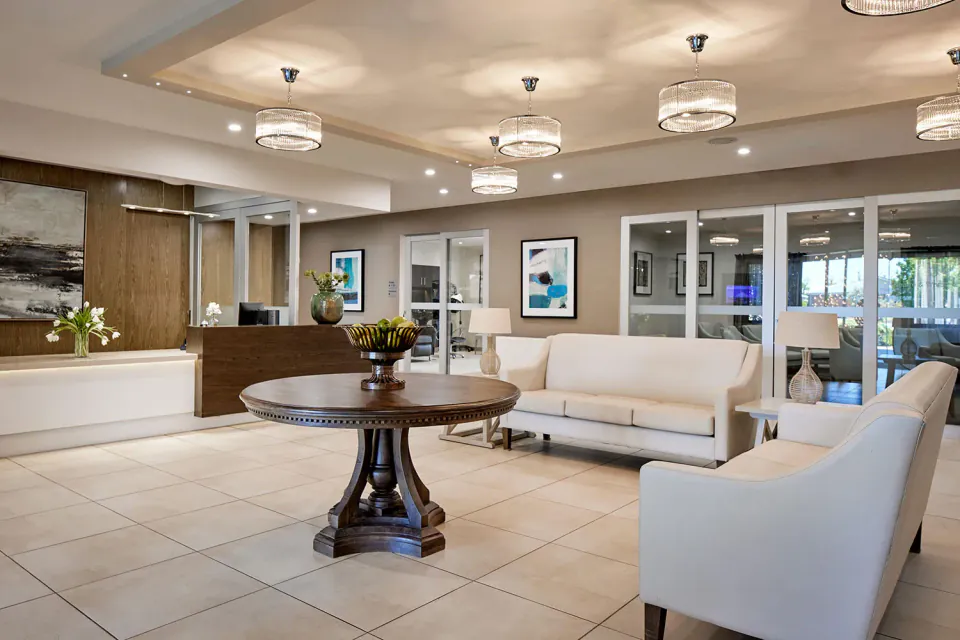 Entrance lounge with reception desk and white sofas