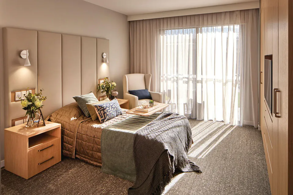 Bedroom with a bed and full-height curtains