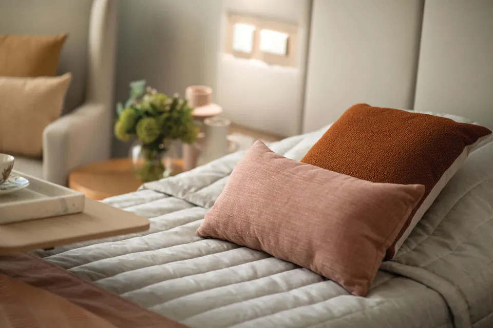 Close view of cushions on a made bed