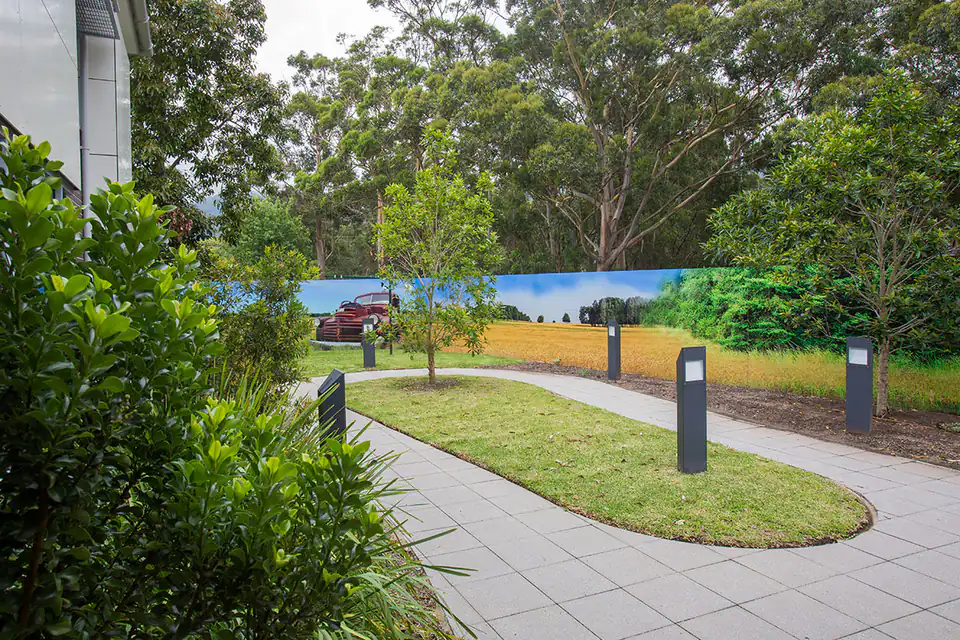 Garden path winding past a lawn and trees