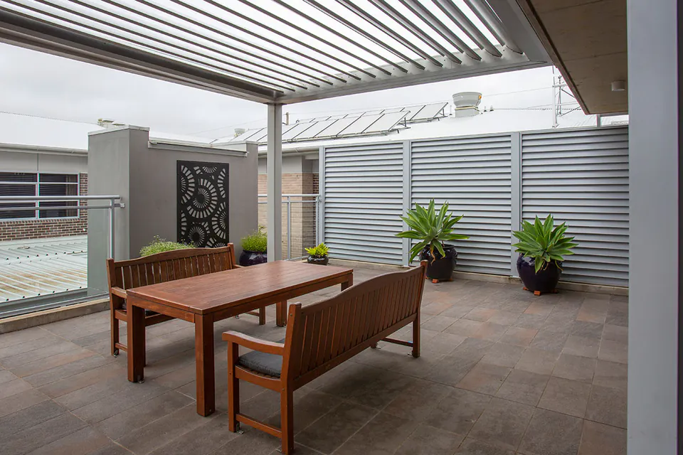 Covered terrace with timber table and bench seats