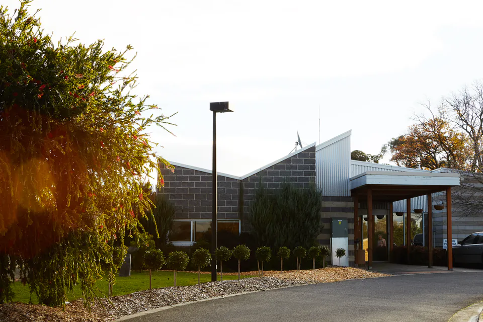 Residence entrance reached by a driveway and garden