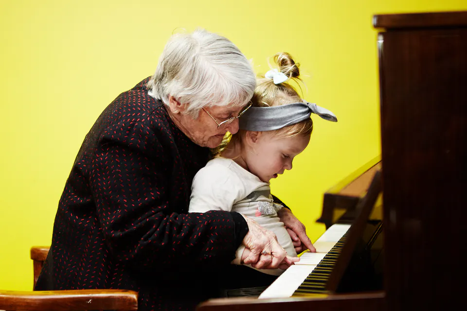 Older woman and child playing a piano together