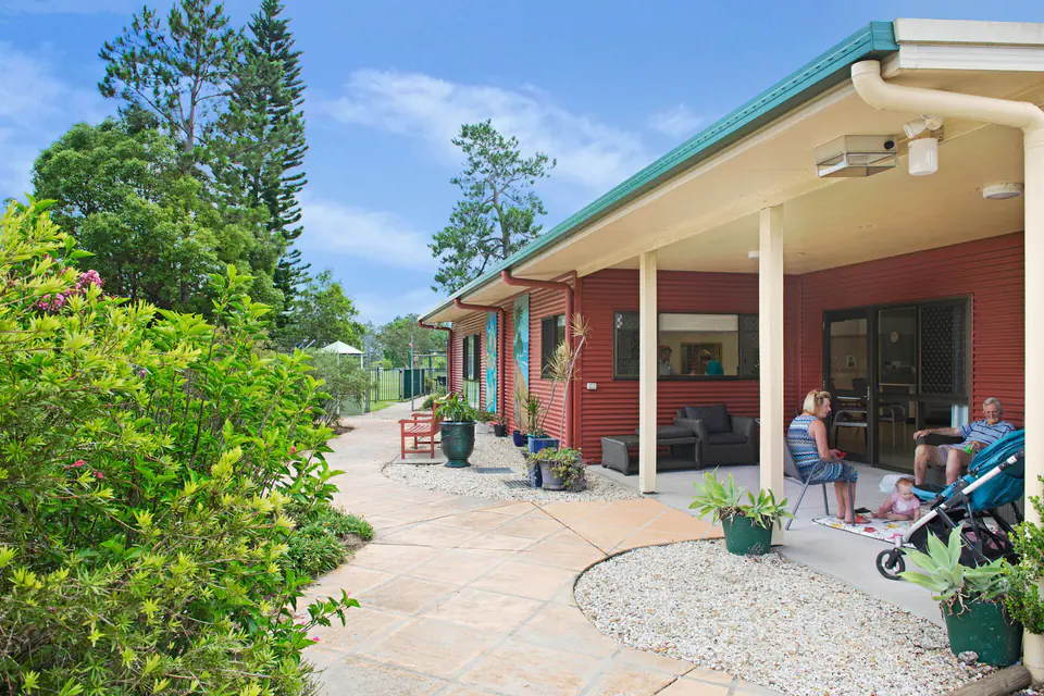 Resident on a covered patio beside the garden