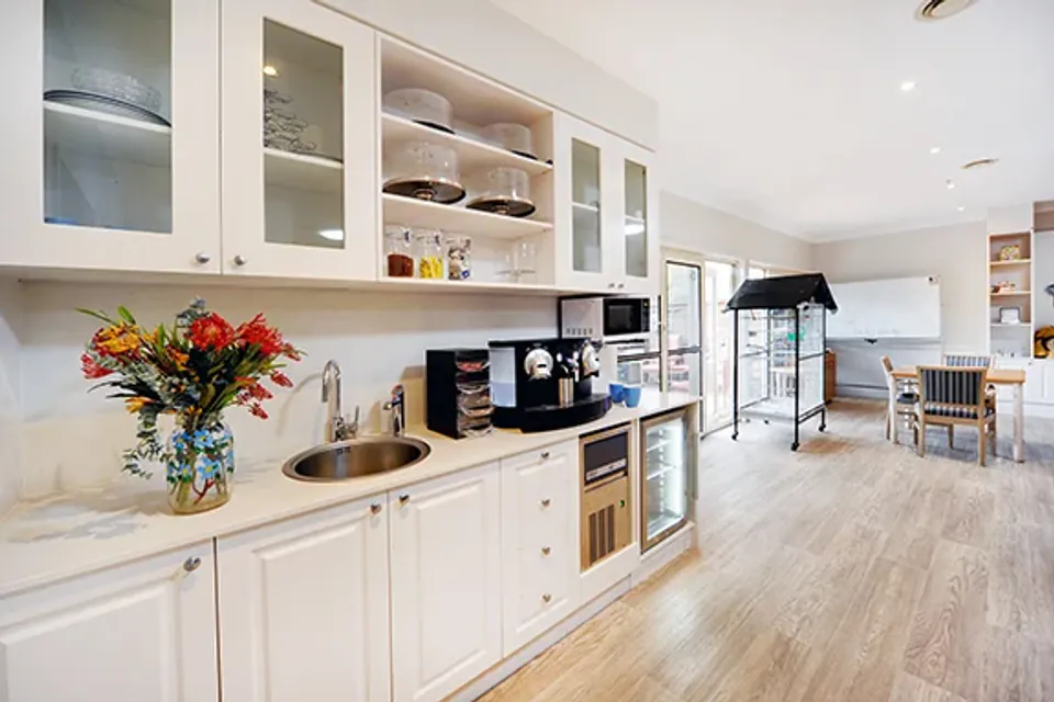 Kitchenette with a coffee machine and dining area