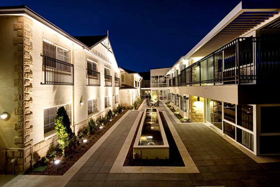Courtyard between illuminated residence wings at night