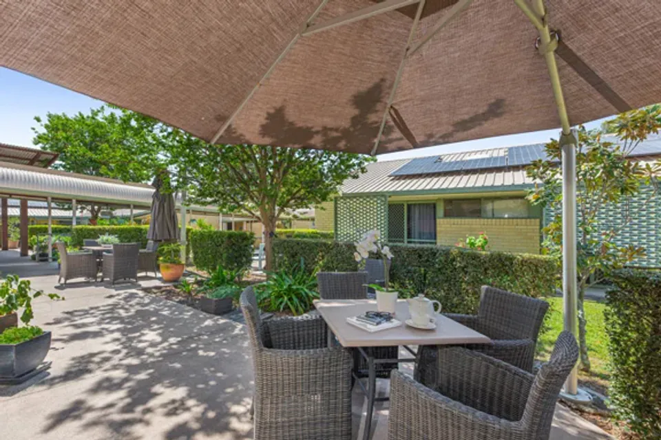 Outdoor tables beneath a shade sail