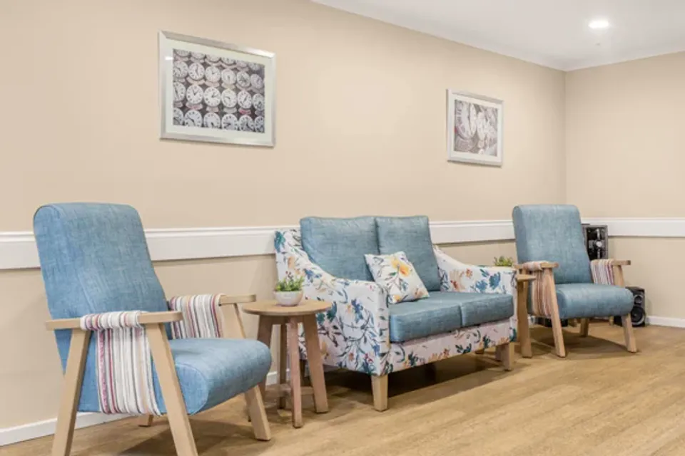 Blue chairs and a sofa in the lounge