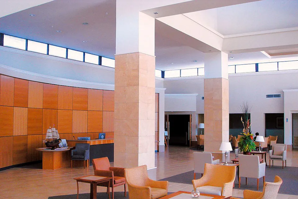 Open communal lounge with chairs and tall columns.