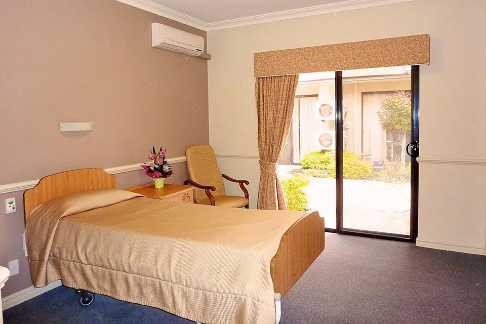 Resident bedroom opening onto a small courtyard.