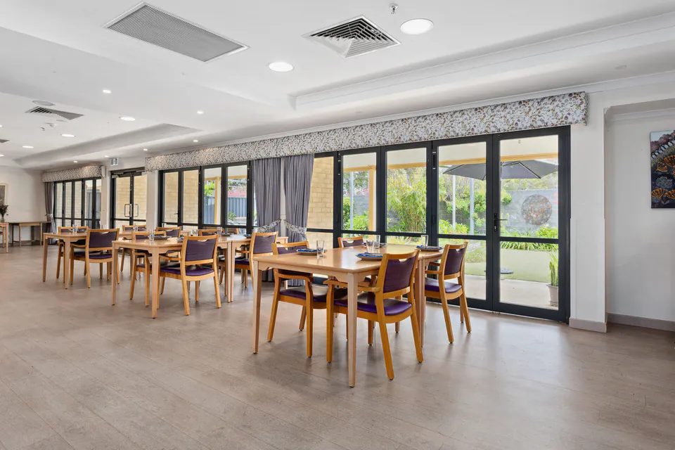 Dining room with tables beside garden-facing doors