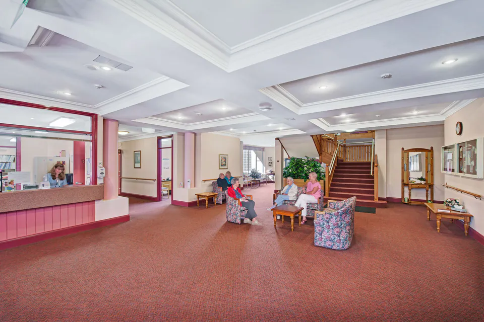 Residents seated in a bright communal hall