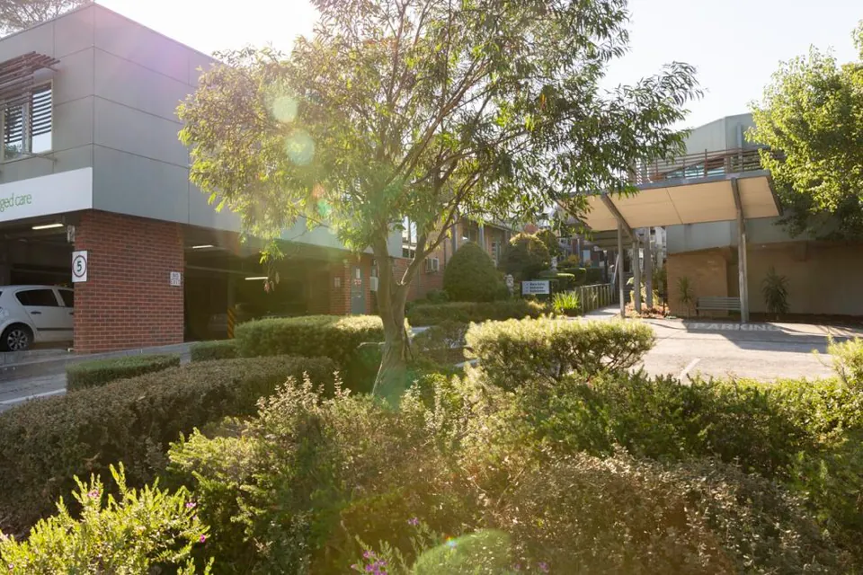 Two-storey residence behind landscaped garden beds