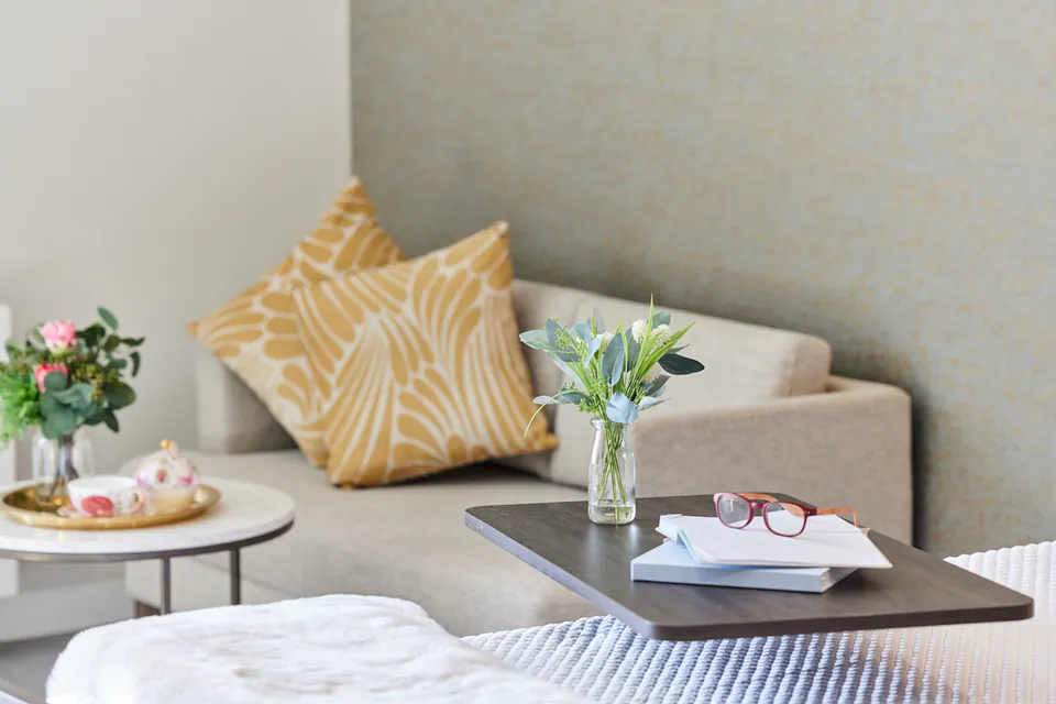 Sofa and flowers beside a table in a sitting area