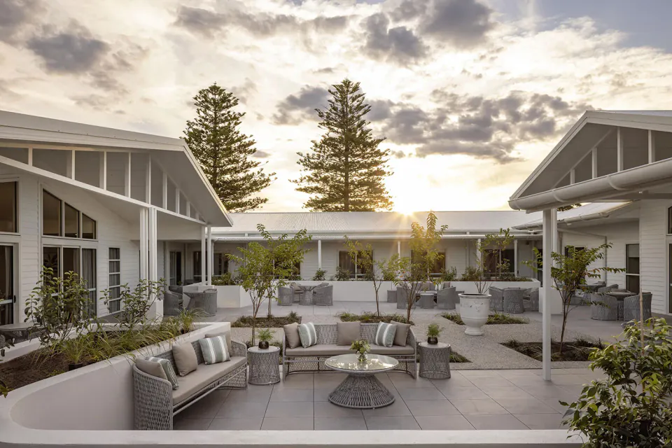 Outdoor courtyard with seating between residence wings