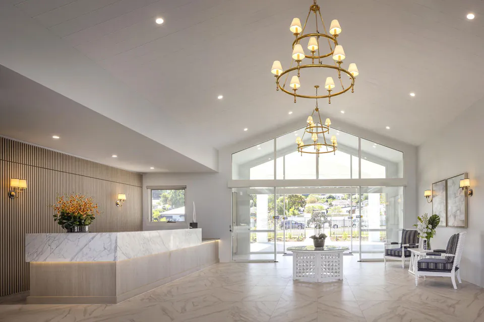 Entrance foyer with reception counter and garden-facing doors