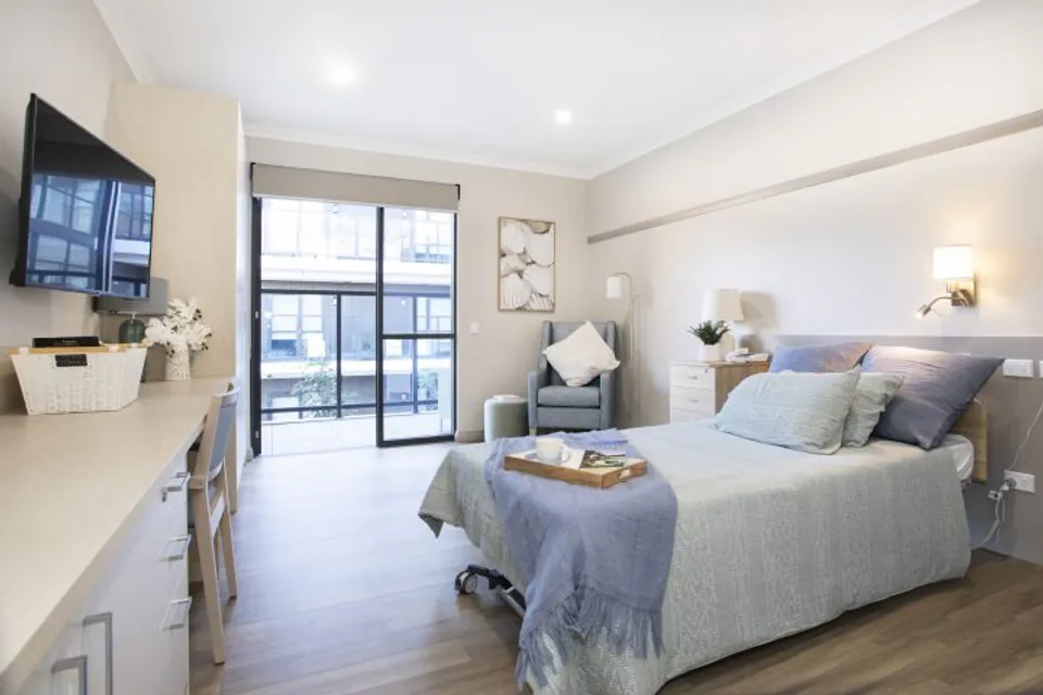 Bedroom with a balcony-facing glass door
