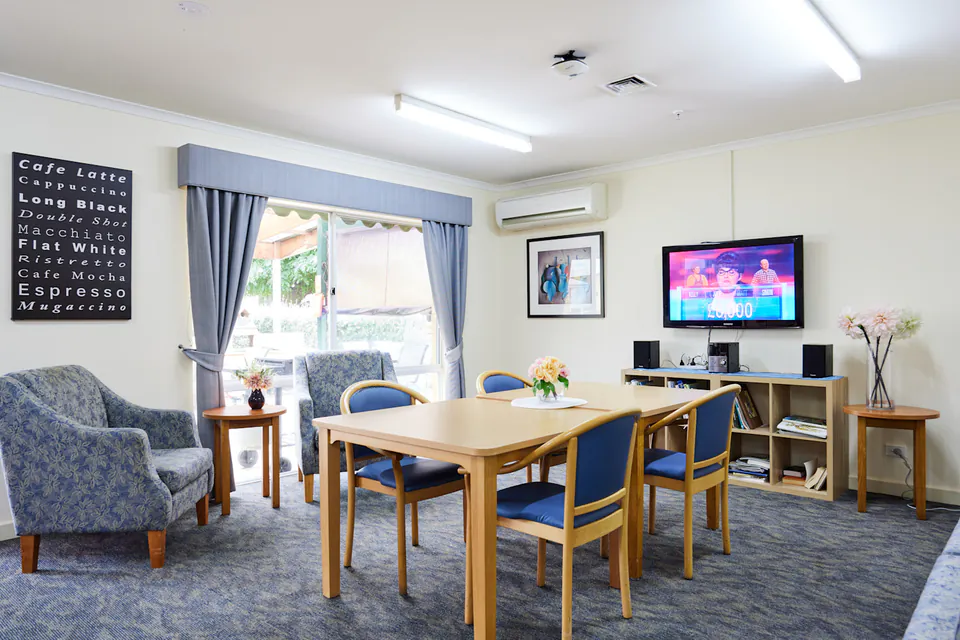 Activity room with table, chairs and television