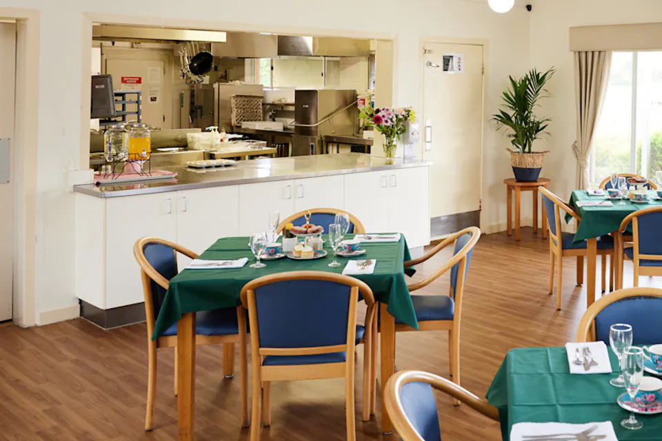 Communal dining room beside a serving kitchen