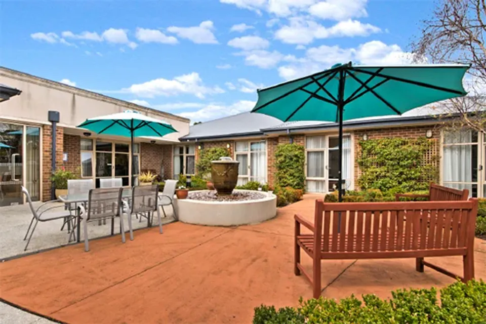 Courtyard tables under green umbrellas