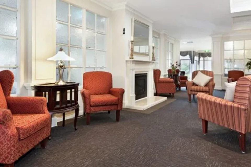 Red armchairs around a fireplace