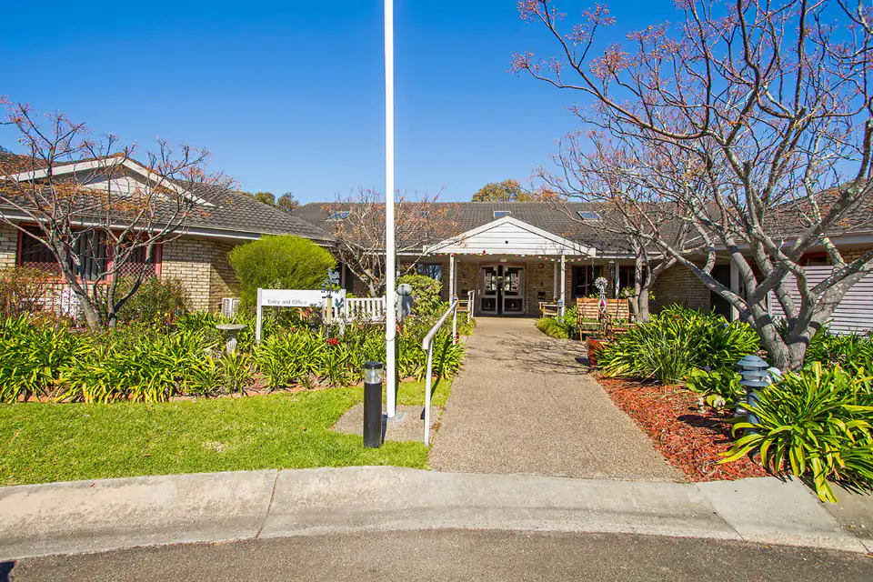 Low brick care buildings and a planted walkway leading to the entrance
